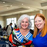 Susan Proctor standing together with young woman, both smiling at camera